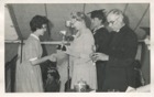 Image 18 of 23 : 1959 Helen Wright receiving the Hitchem Music Cup from Archbishop Selwyn Bean with Miss Robinson, Head Mistress, to his right